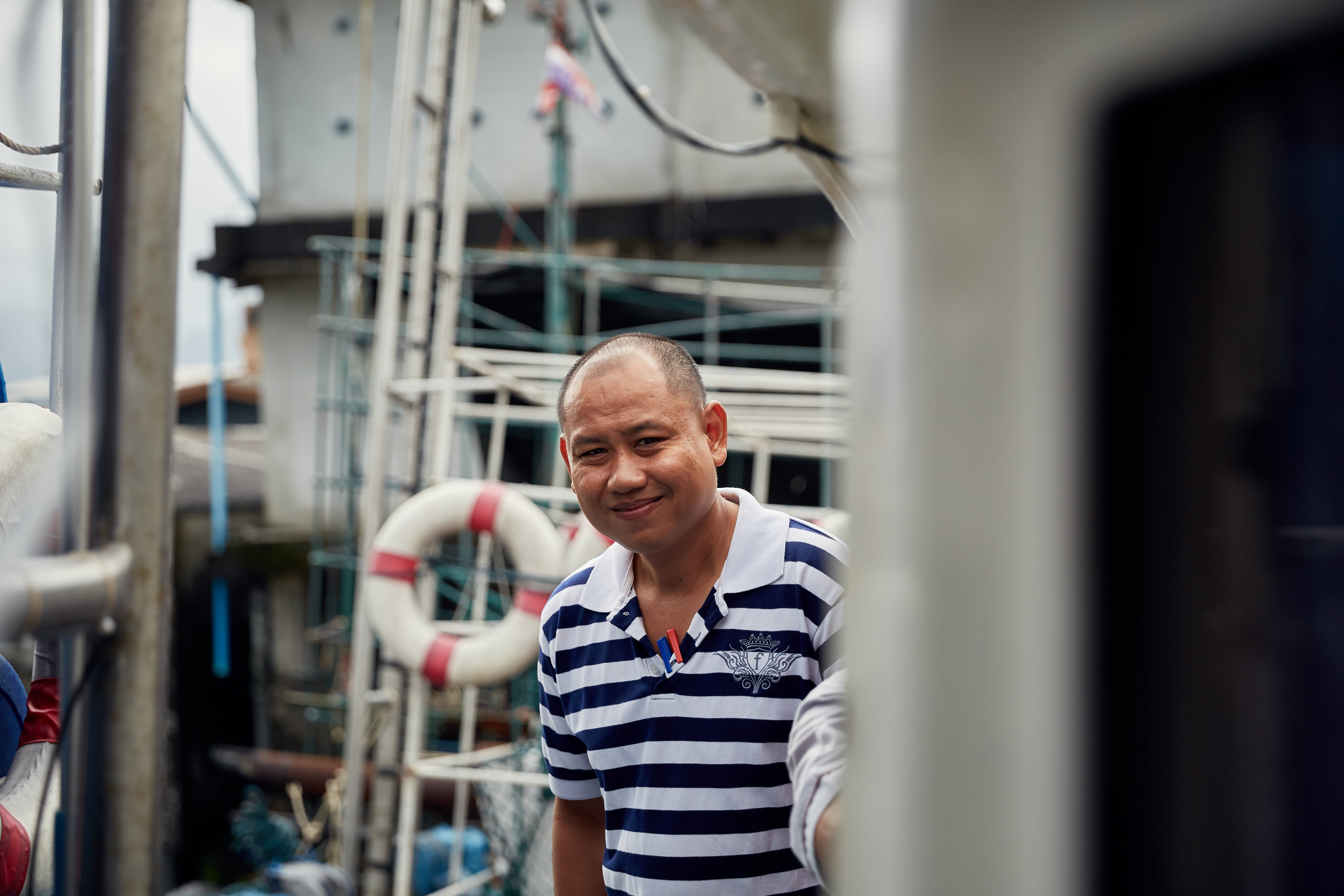 A man smiling onboard a fishing vessel in the south of Thailand. Photo credit: Thai Union