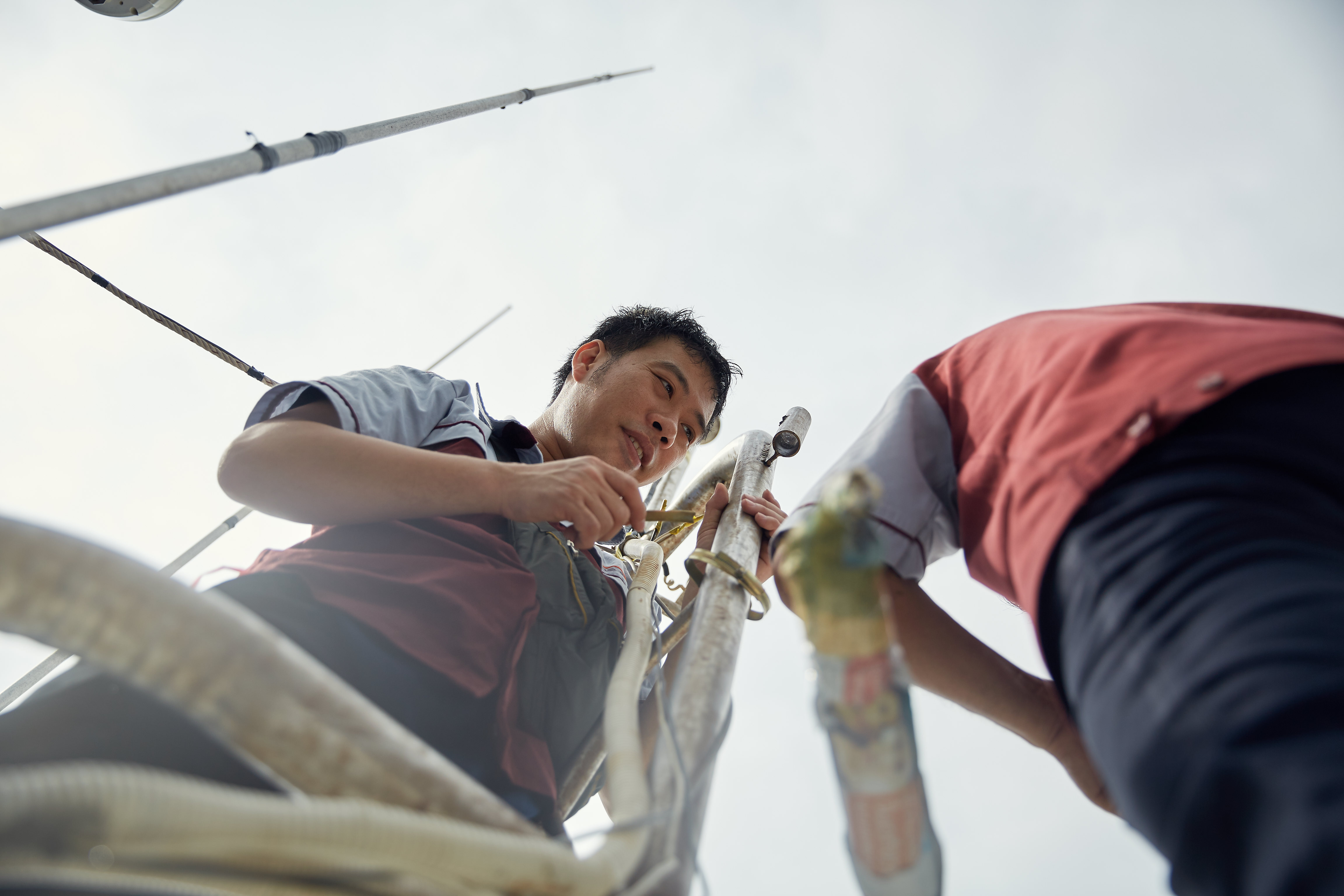 Teams work to install technology on a Thai fishing vessel to bring digital traceability to Thailand’s fishing industry. Photo credit: Thai Union